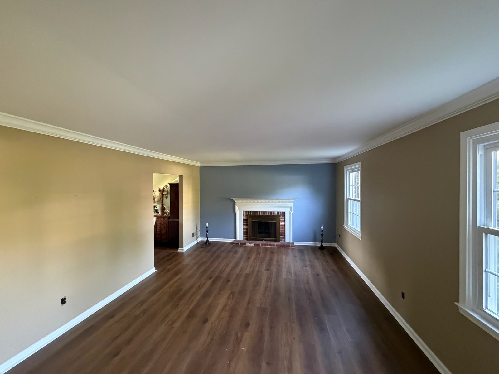 Same living room reimagined in a calming slate blue accent wall